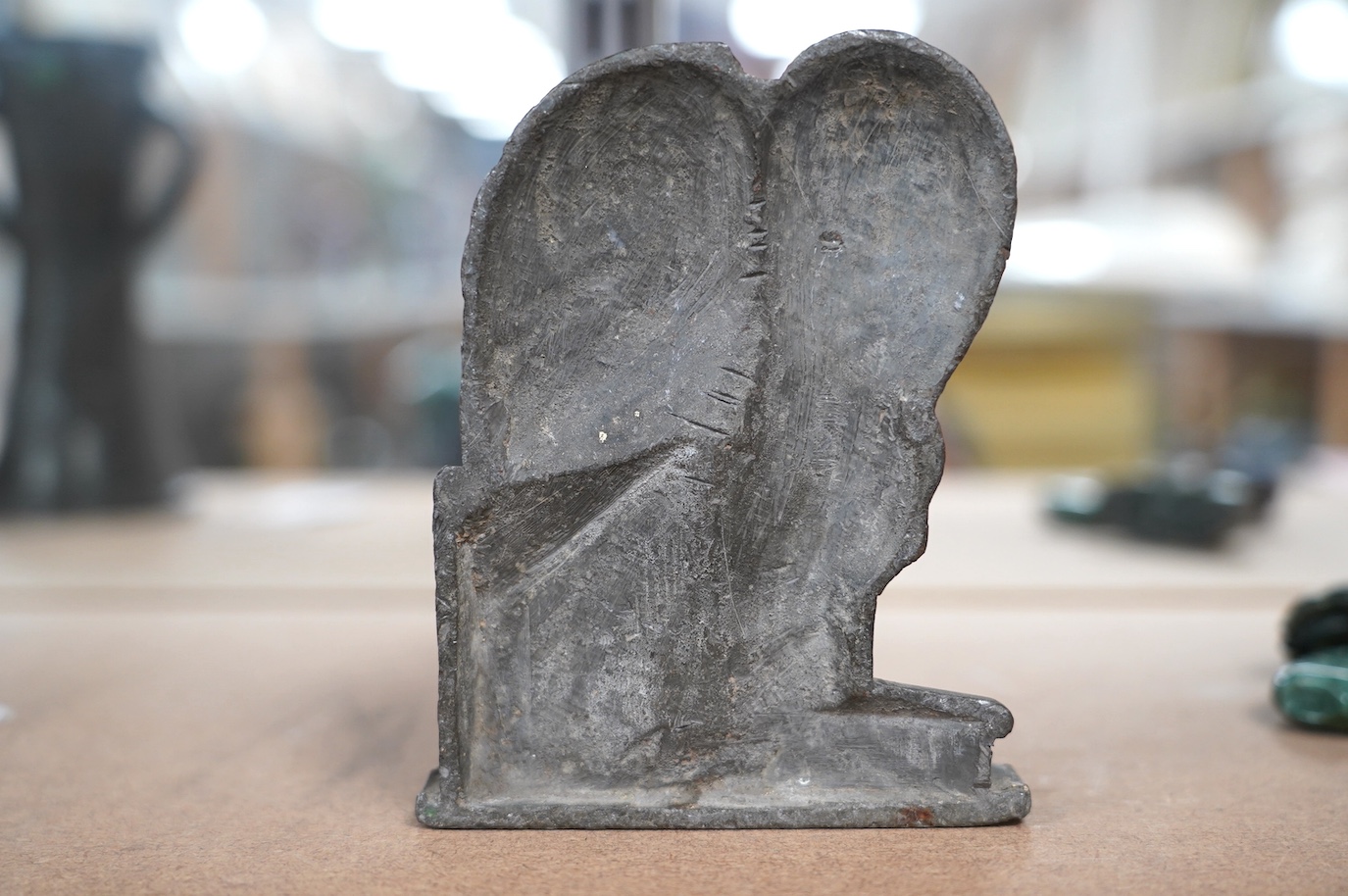 Follower of William Blake, a lead relief of a crouching figure, ex-studio of Fred Cuming, 15cm high. Condition - fair to good